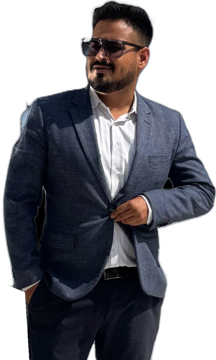Rohit Kumar Jha in a navy blazer, turned slightly, hands in pockets